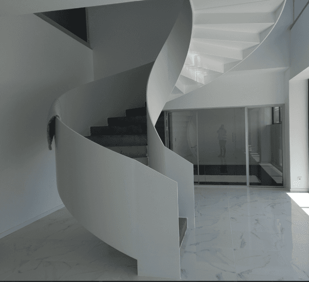 a large circular building with a staircase leading up to it